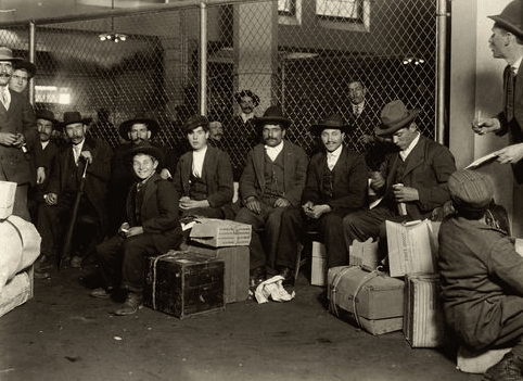 A group of Italians in the railroad waiting room, Ellis Island, 1905