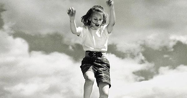 Sally Mann photograph of girl jumping in clouds