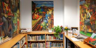 Latino and Puerto Rican Cultural Center, featuring colorful art and bookshelves lining the walls.