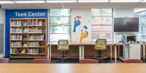 Allerton Library Teen Center, featuring work tables, books, colorful wall art, a smart board, and a 3-D printer.